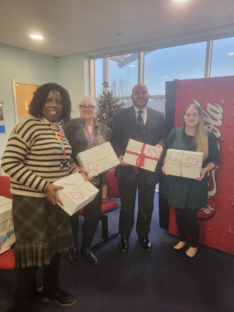 The team holding the shoeboxes